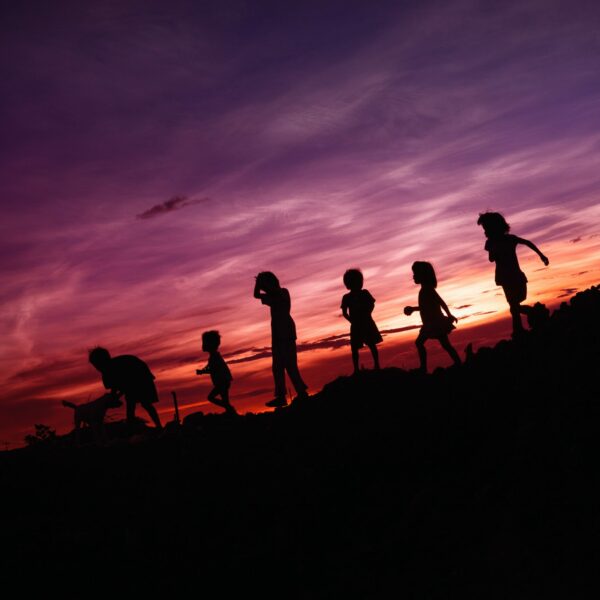 silhouette of children's running on hill